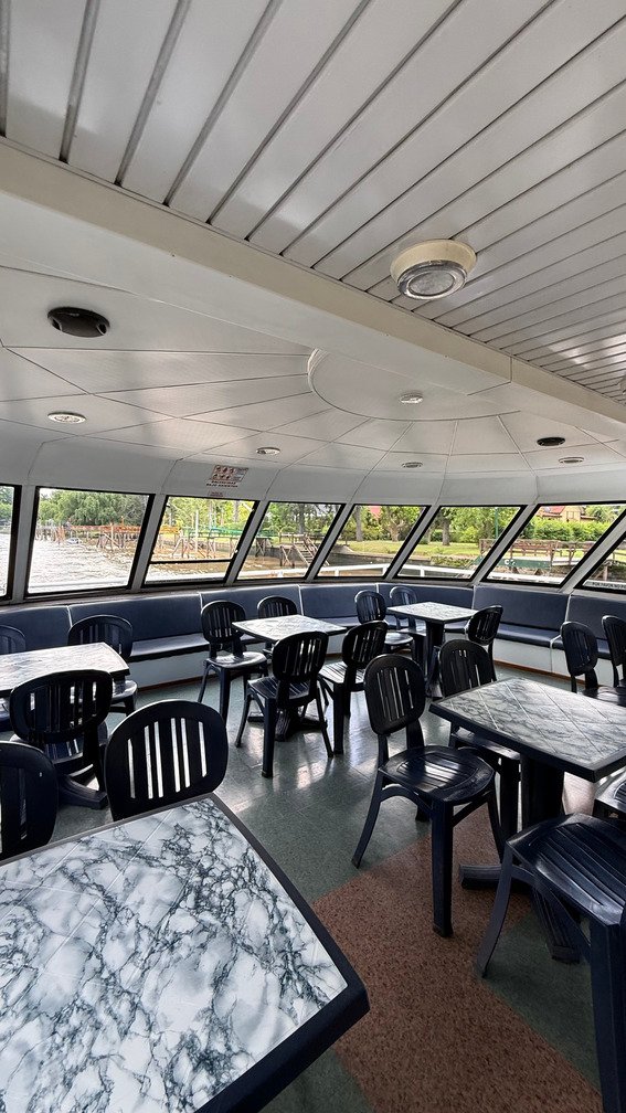 mesas y sillas en un catamaran de paseo navegando